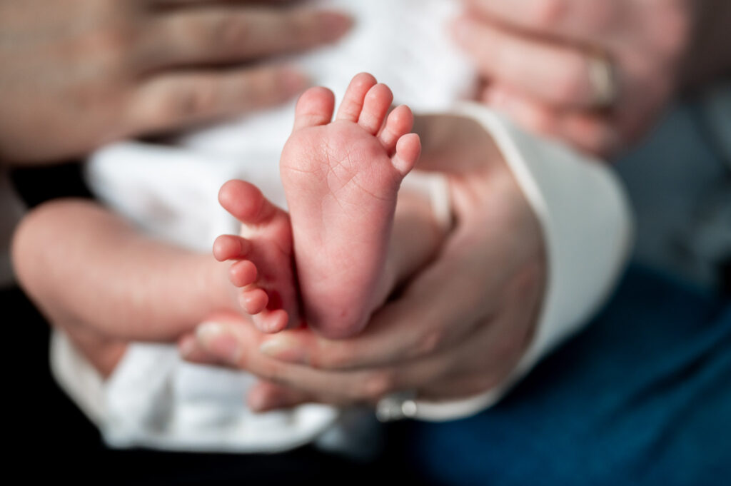 baby feet in moms hand