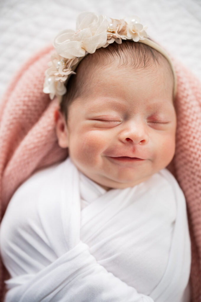 baby smiling with floral headband